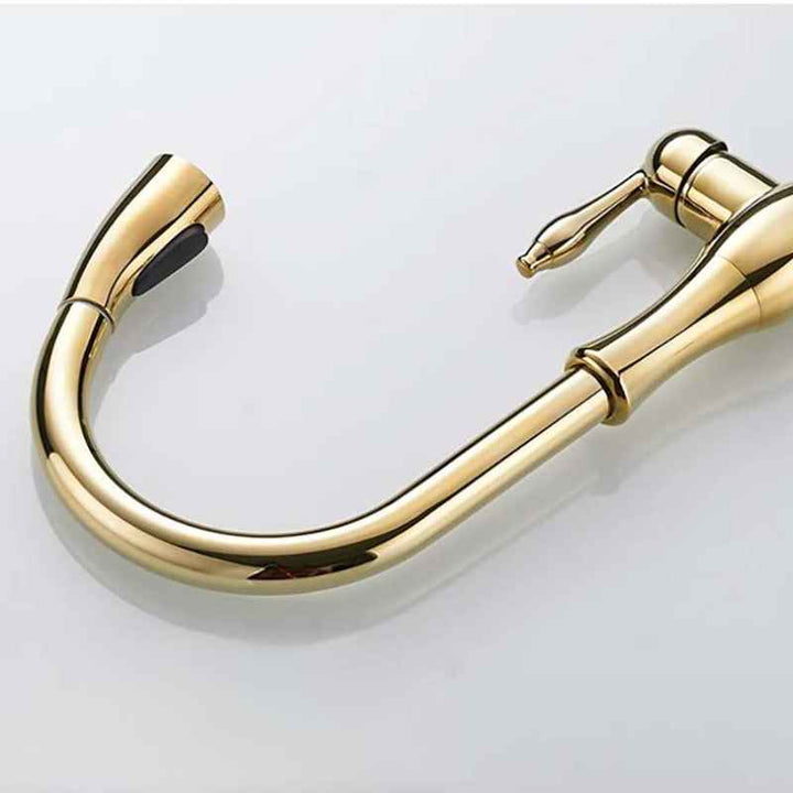 Gold kitchen faucet on a light gray background