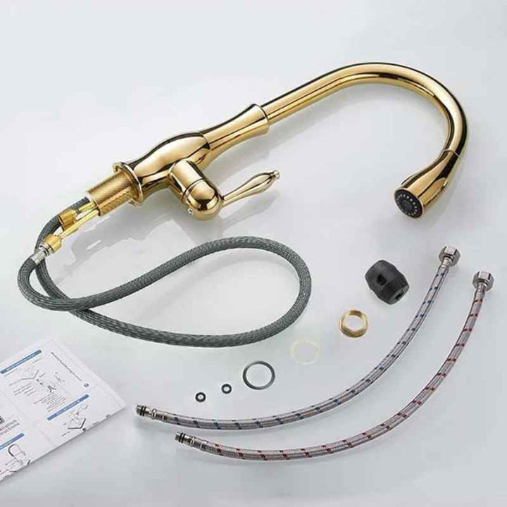 Gold kitchen faucet with hoses and parts on a light gray background