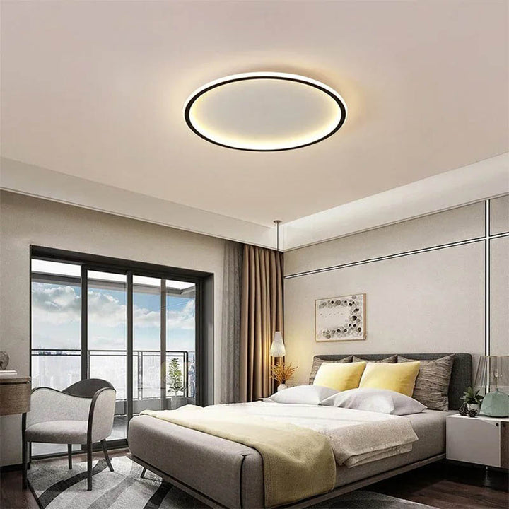 Nordic Essentials RUND LED ceiling light in black, 80cm, illuminating a modern bedroom with adjustable brightness.