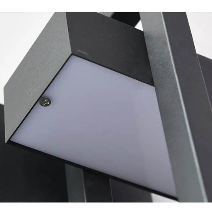 Close-up of modern black LED garden wall sconce showing durable waterproof aluminium build and frosted light panel