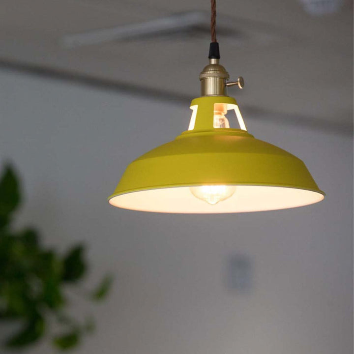 Yellow retro industrial pendant light hanging against a neutral background