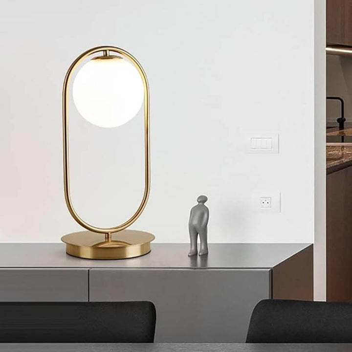 Minimalist oval brass lamp with frosted glass globe, Nordic-inspired design for hallway or dining room