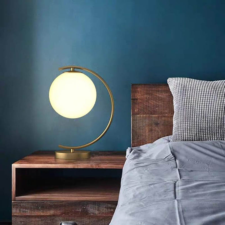 Minimalist oval brass lamp with frosted glass globe, Nordic-inspired design for living room or bediside