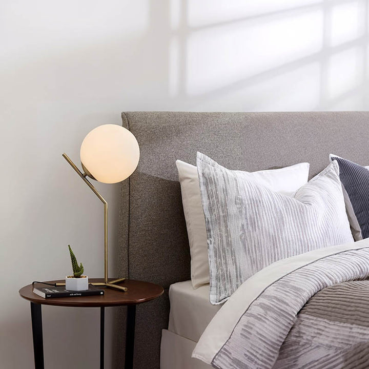 Minimalist oval brass lamp with frosted glass globe, Nordic-inspired design for uk bedrooms