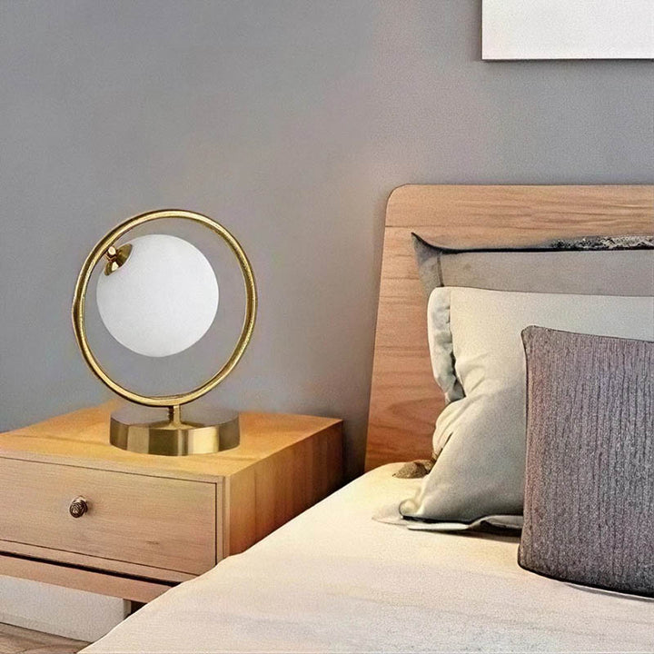 Small gold ring lamp on bedside table, Nordic-style brass frame with warm white light for uk bedroom lighting