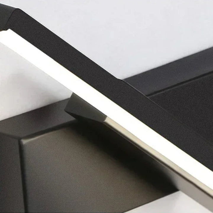 Close-up of a black rotatable led wall light on gray background