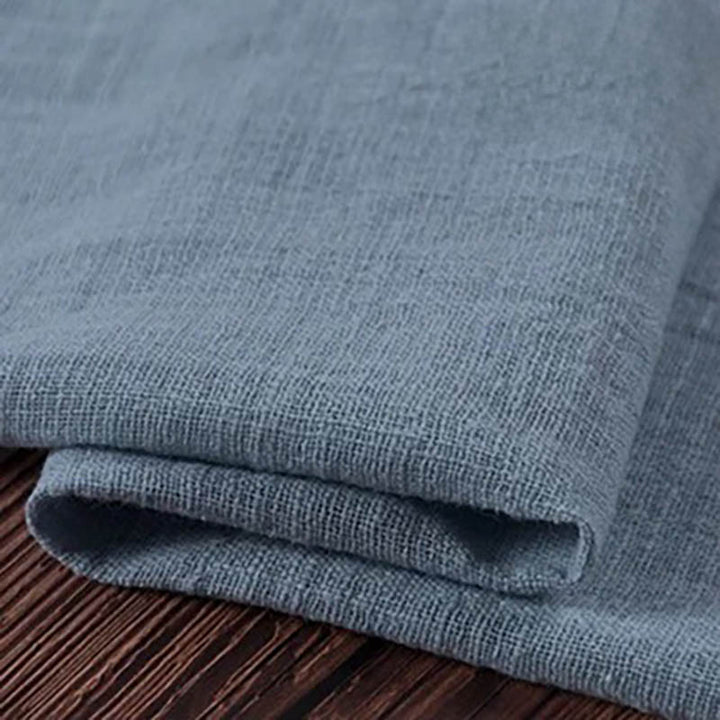 Folded blue cotton napkin for Weddings and Elegant uk Dining Decor on the white table.