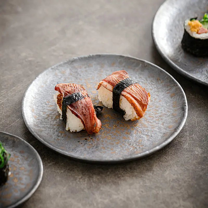 Rustic grey stoneware shallow ceramic serving plate styled with sushi, 22 cm diameter