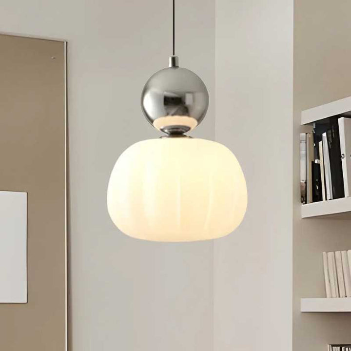 Single chrome-accent Art Deco pendant lamp with white glass shade illuminating modern study area
