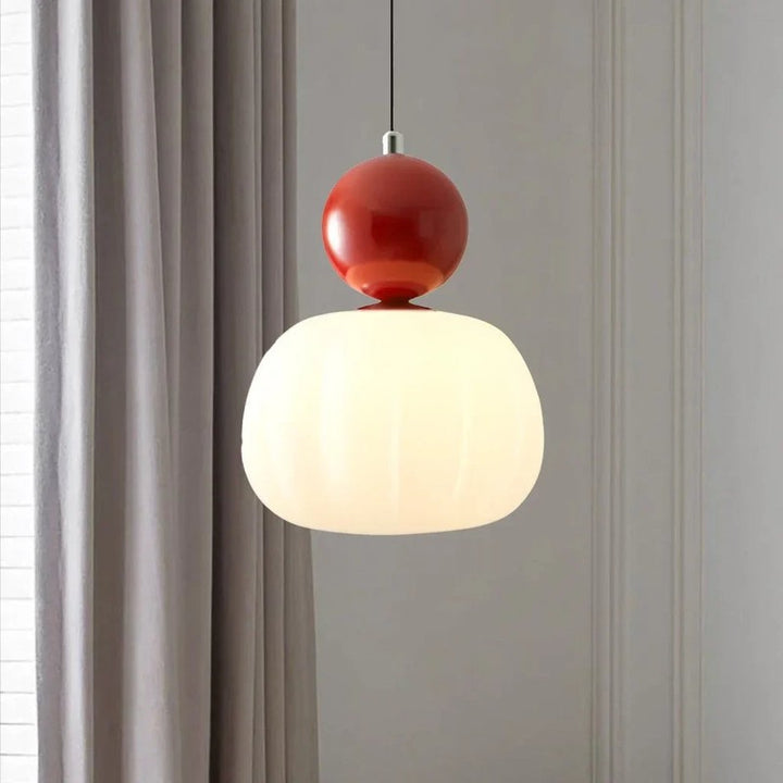Red-accent Nordic Art Deco pendant light with white glass shade hanging in modern room