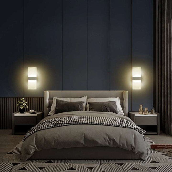 Bedroom interior with two modern LED wall lamps mounted on each side of the bed, creating a warm and cozy atmosphere.