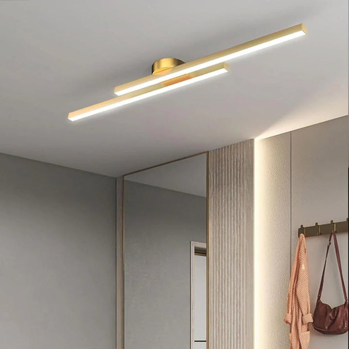 Gold aluminium LED strip ceiling light fixture adding elegance to entryway.