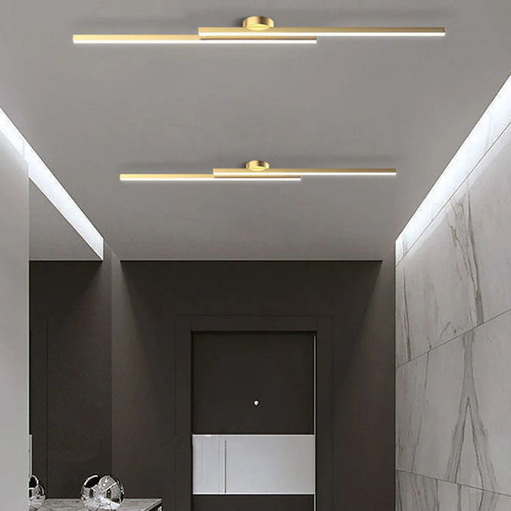 Twin gold aluminium LED strip ceiling lights in luxury hallway interior.