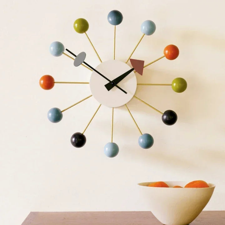 Silent Nordic wall clock styled in modern dining room with silver frame and coloured accents