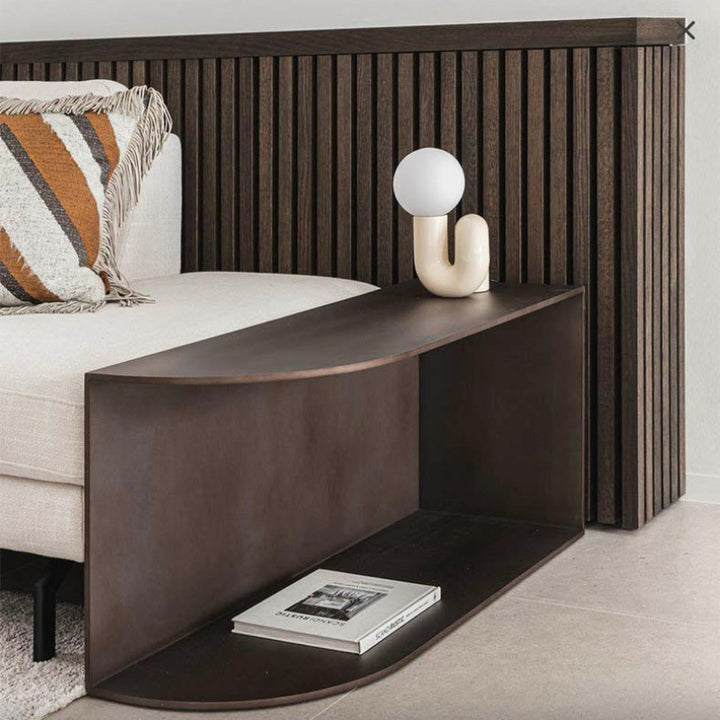 Scandinavian resin table lamp with white globe shade placed on a dark wood console, perfect for reading nooks or living rooms.