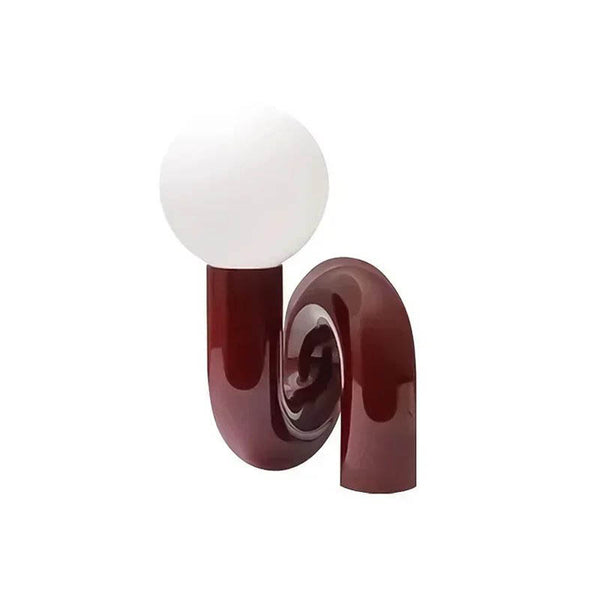 Modern Scandinavian table lamp with curved burgundy resin base and frosted glass globe shade, ideal for UK ambient lighting.