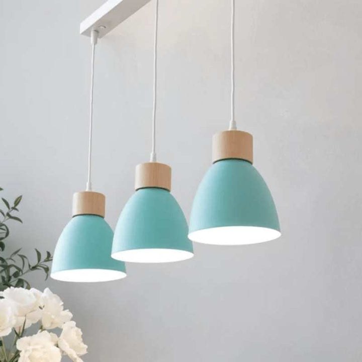 Set of three light blue pendant lights with wood accents on white rectangular ceiling base