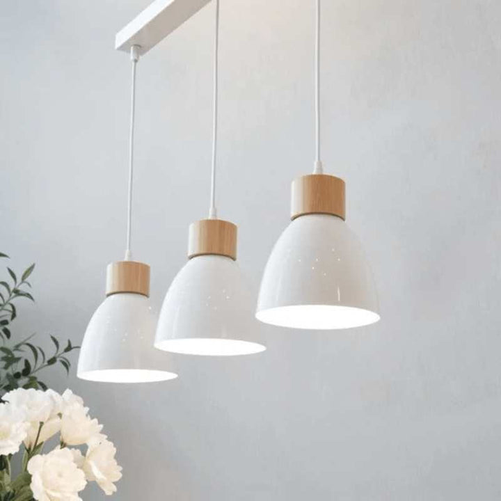 Set of three glossy white pendant lights with wooden tops on rectangular base