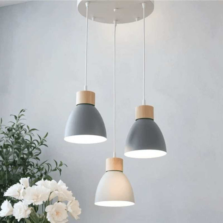Grey pendant lights with wooden accents on a round ceiling plate