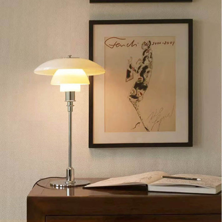 Nightstand Light on a wooden surface with a framed artwork in the background