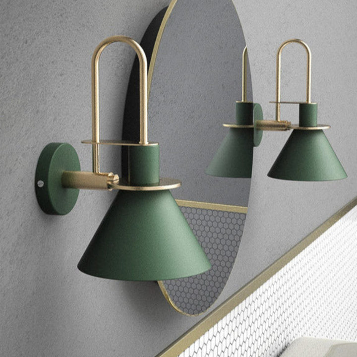 Green wall sconces with gold accents on a gray wall.