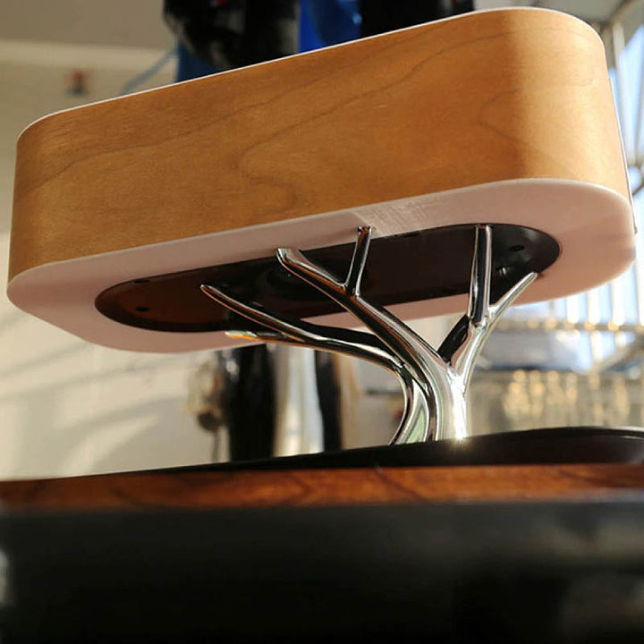 Underside of smart bedside lamp with curved wood casing and integrated speaker