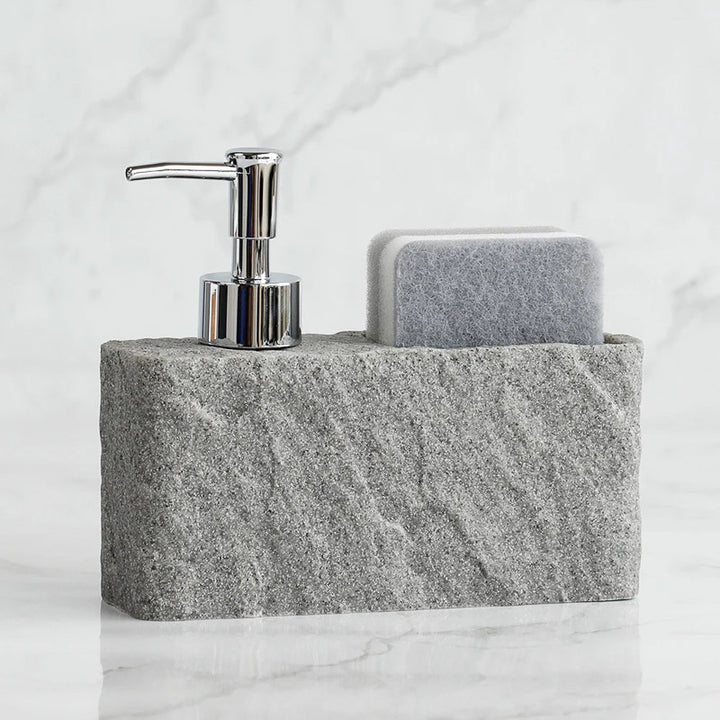 Soap dispenser on a stone soap dish with a marble background