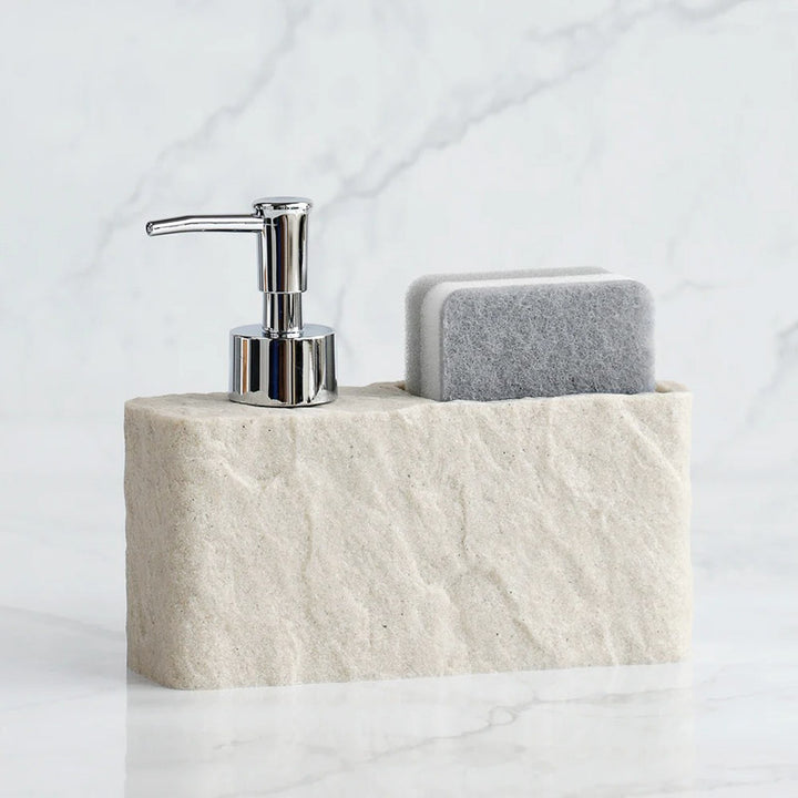 Soap dispenser and sponge on a stone holder with a marble background