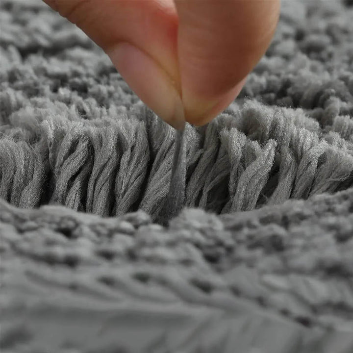 Soft coral fleece fibres of grey bath mat showing high pile density and durability for everyday use