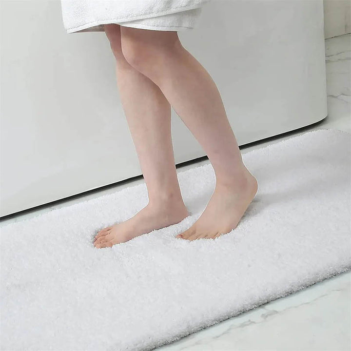 A person standing on a White soft quick-dry bathroom mat 