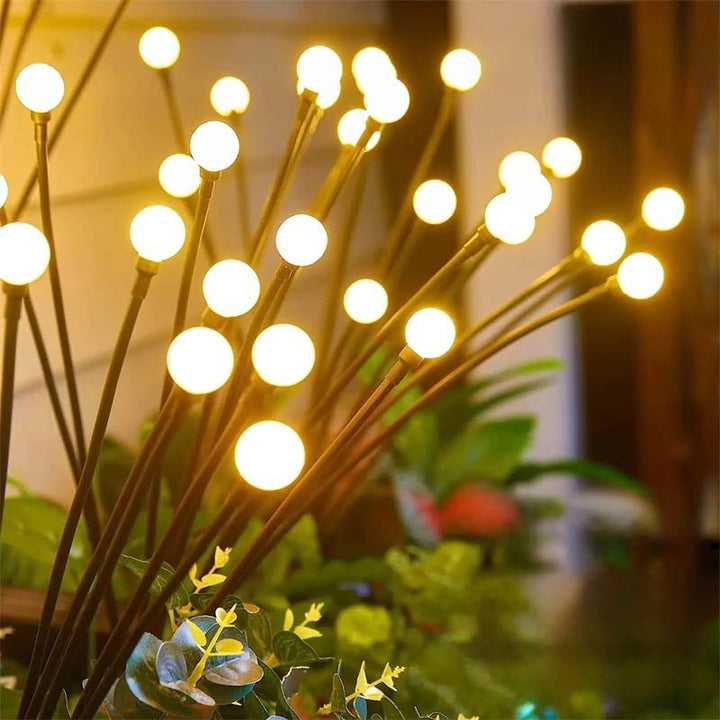 LED solar lawn lights with firefly effect swaying gently in garden for ambient nighttime charm