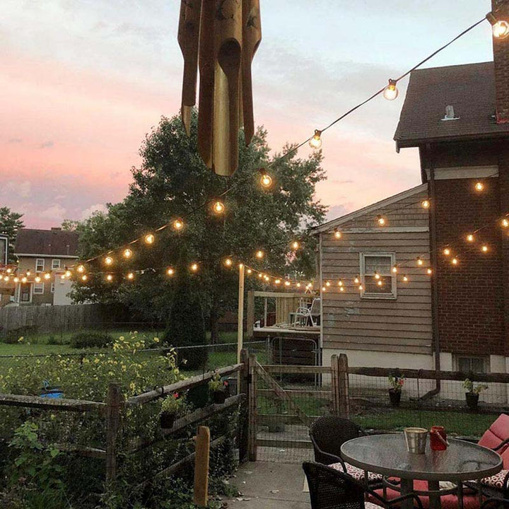 Solar-powered LED string lights lighting up home exterior, perfect for festive and everyday outdoor decoration.
