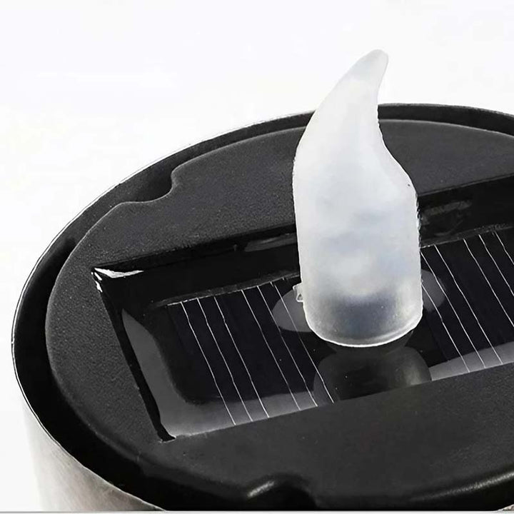 Close-up of solar LED candle base with built-in solar panel and flame-shaped LED tip, designed for eco-friendly lighting.