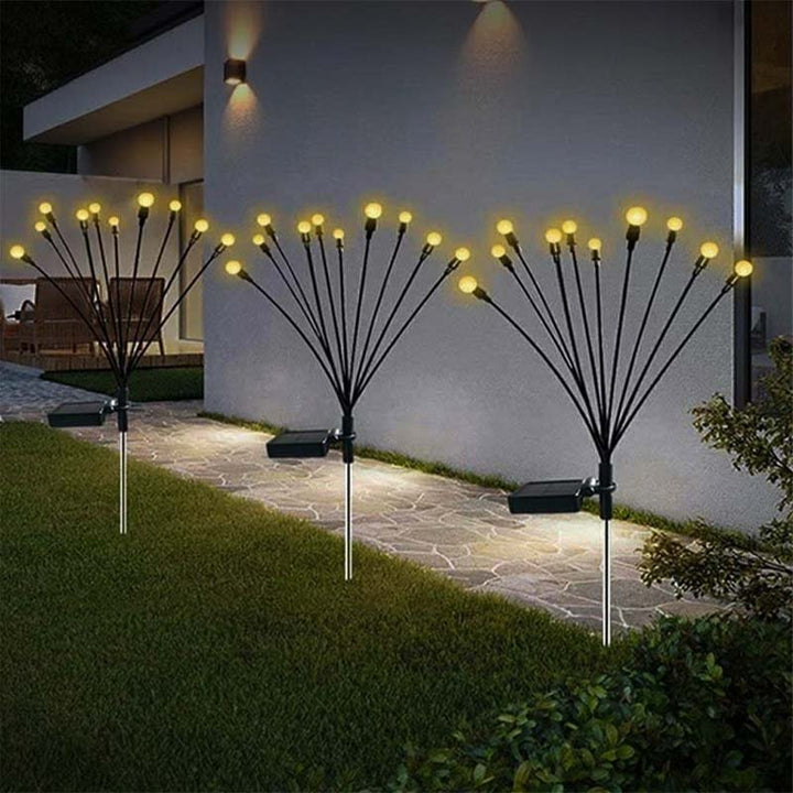 Cluster of LYSGNIST solar garden lights glowing warmly for festive outdoor atmosphere