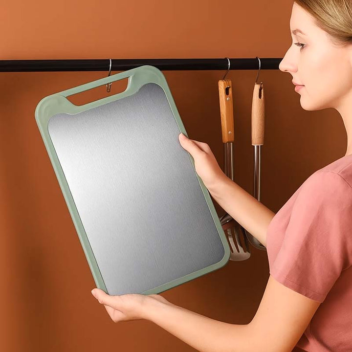 Woman holding a green Stainless-Steel chopping board with a brown wall background