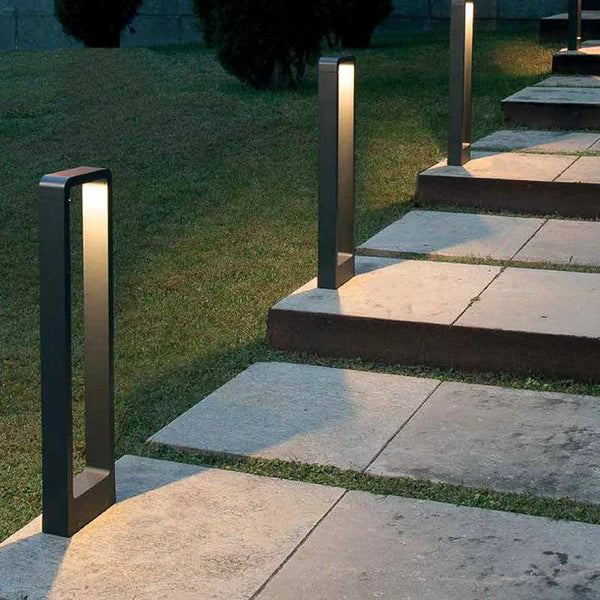Outdoor garden LED lighting fixtures on stone steps and grass