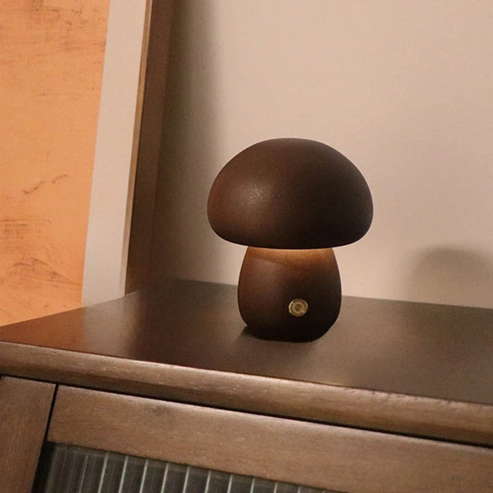 Mashroom touch switch lamp placed on wooden table against peach wall, used as calming evening light.
