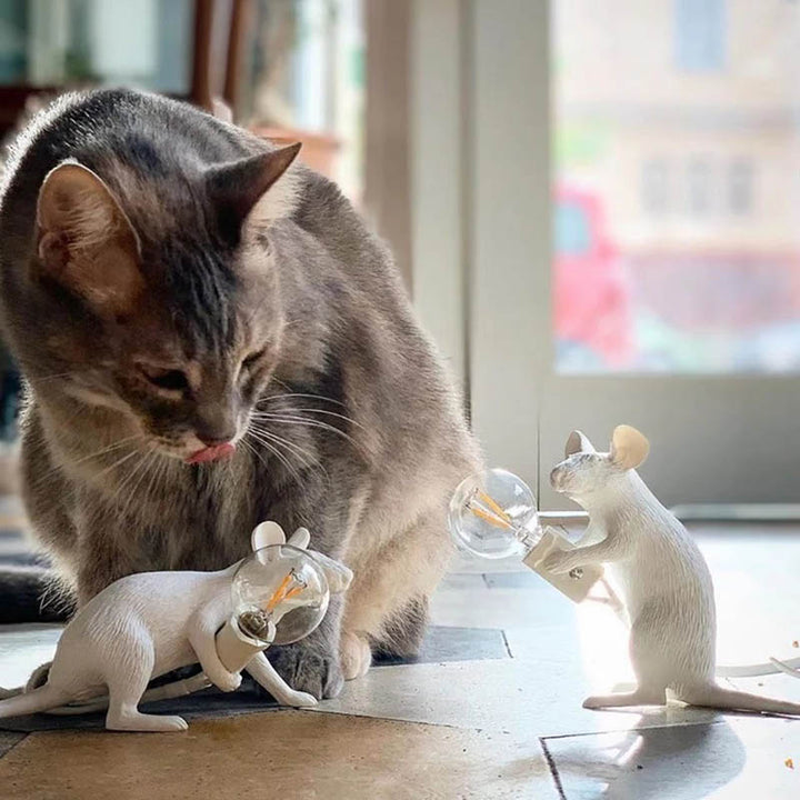 Curious cat interacting with two white mouse-shaped LED lamps—fun, pet-friendly novelty lighting for UK eclectic homes.
