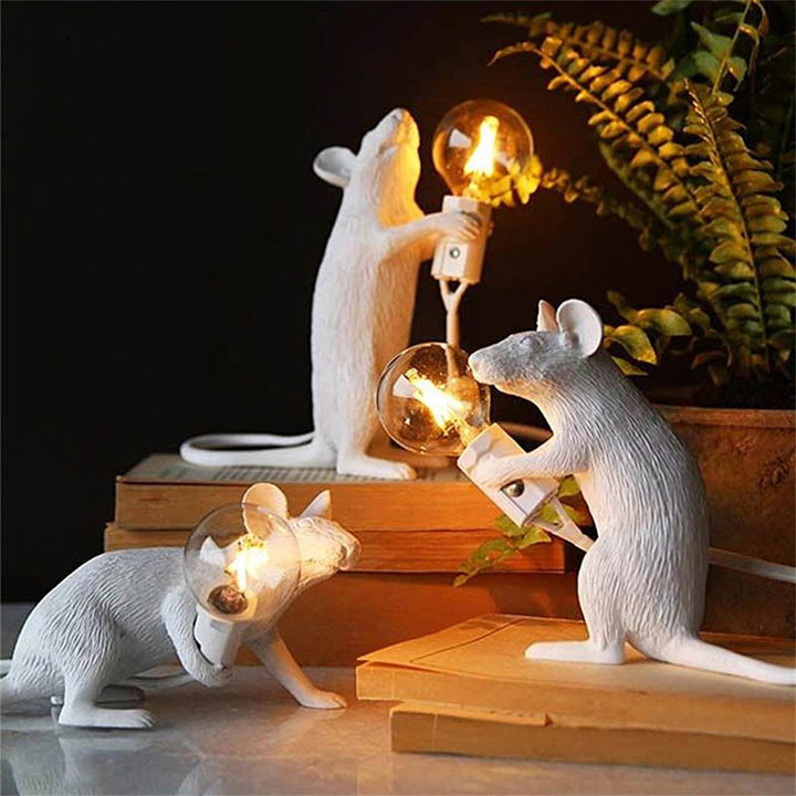 White mouse LED lamps styled on stacked books with warm glowing bulbs—whimsical decorative lighting for living rooms or bookshelves.