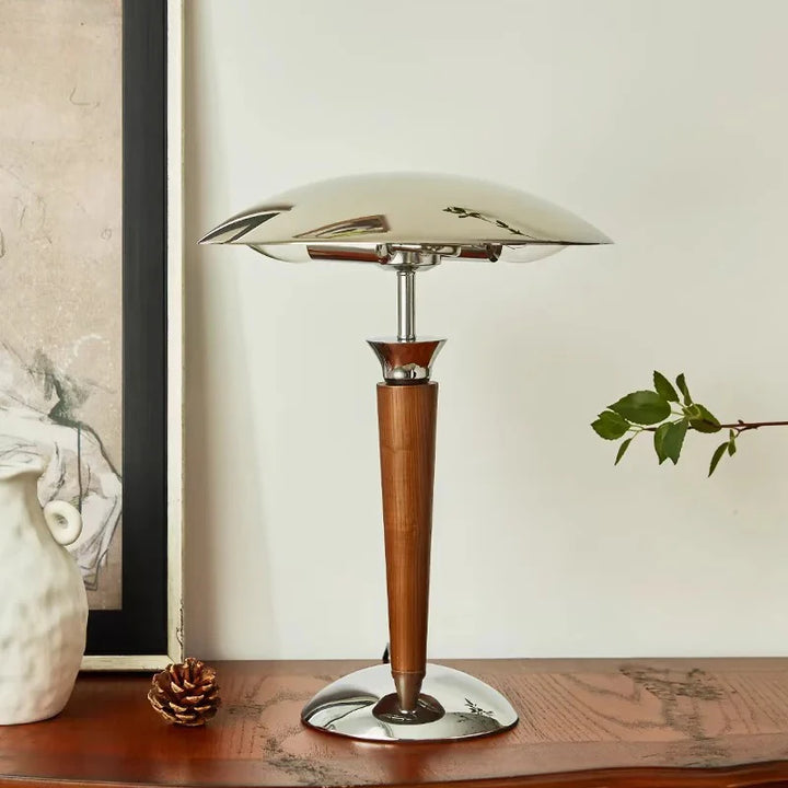 Scandinavian desk lamp with wooden stem and chrome dome shade on wooden console