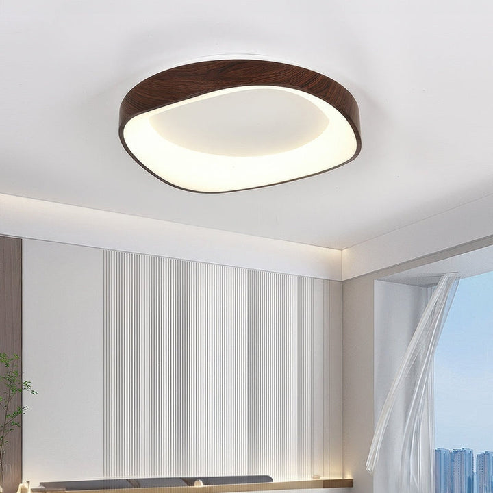 Dark wood LED ceiling light in modern bedroom, Scandinavian flush mount with natural finish