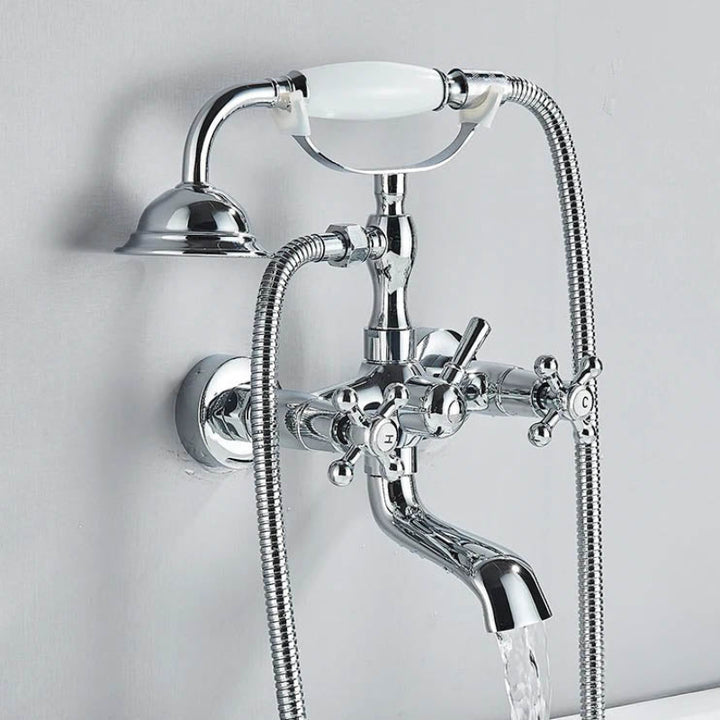 Polished chrome vintage shower faucet with handheld head and curved bath spout, water running into tub.