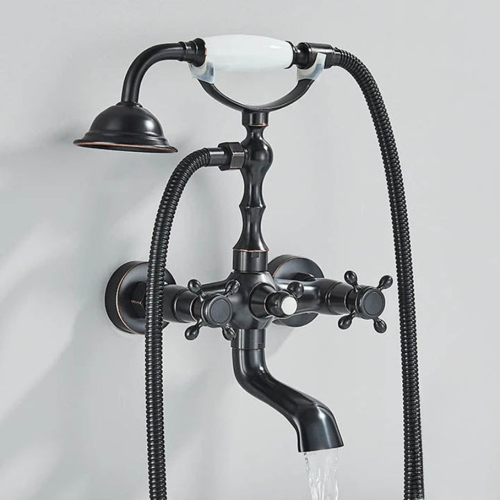 Matt black chrome vintage shower faucet with handheld head and curved bath spout, water running into tub.