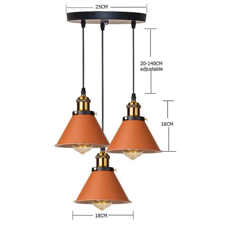 Trio orange retro pendant lamps with brass detail, round ceiling plate, adjustable hanging cord.