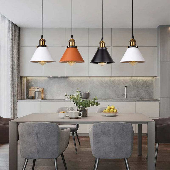 Four cone-shaped industrial pendant lights in black, white, and brown illuminating dining area.