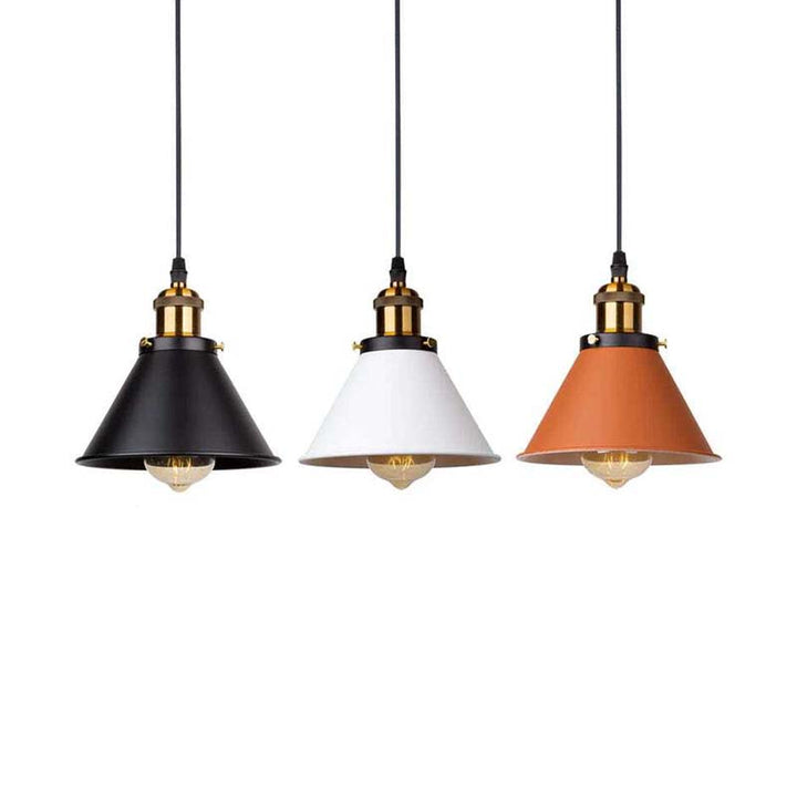 Three industrial  pendant lights with black, white, and orange shades on a white background