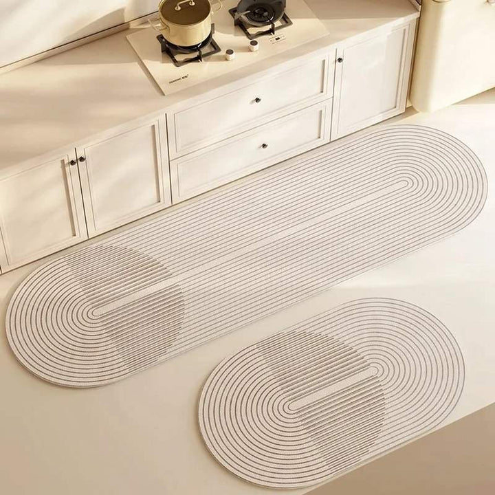 Two oval-shaped kitchen rugs with circular patterns on a light-colored floor.