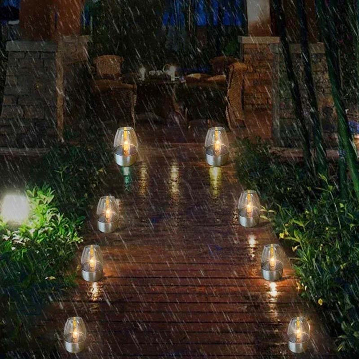 Pathway illuminated by solar LED candle lights, providing ambient outdoor lighting along brick garden steps.