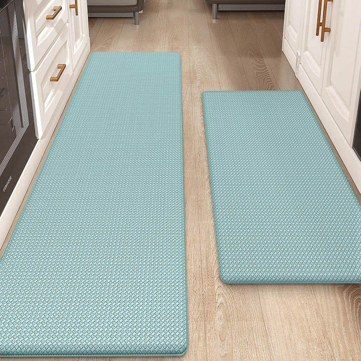 Two light blue kitchen mats on a wooden floor in a home setting.
