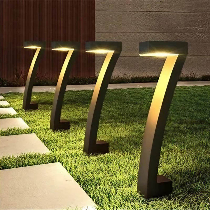 Matte black 7-shape modern solar garden lights illuminating a stone pathway with warm LED glow